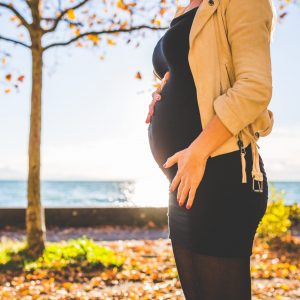 pregnant-woman-wearing-beige-long-sleeve-shirt-standing-near-132730